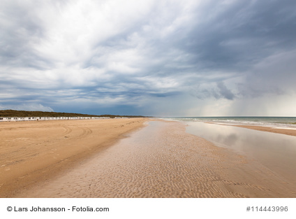 Beach at Lokken in Denmark with dark storm clouds